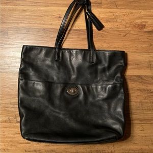 Leather Coach bag, black with decorative tassels and silver tone closure.